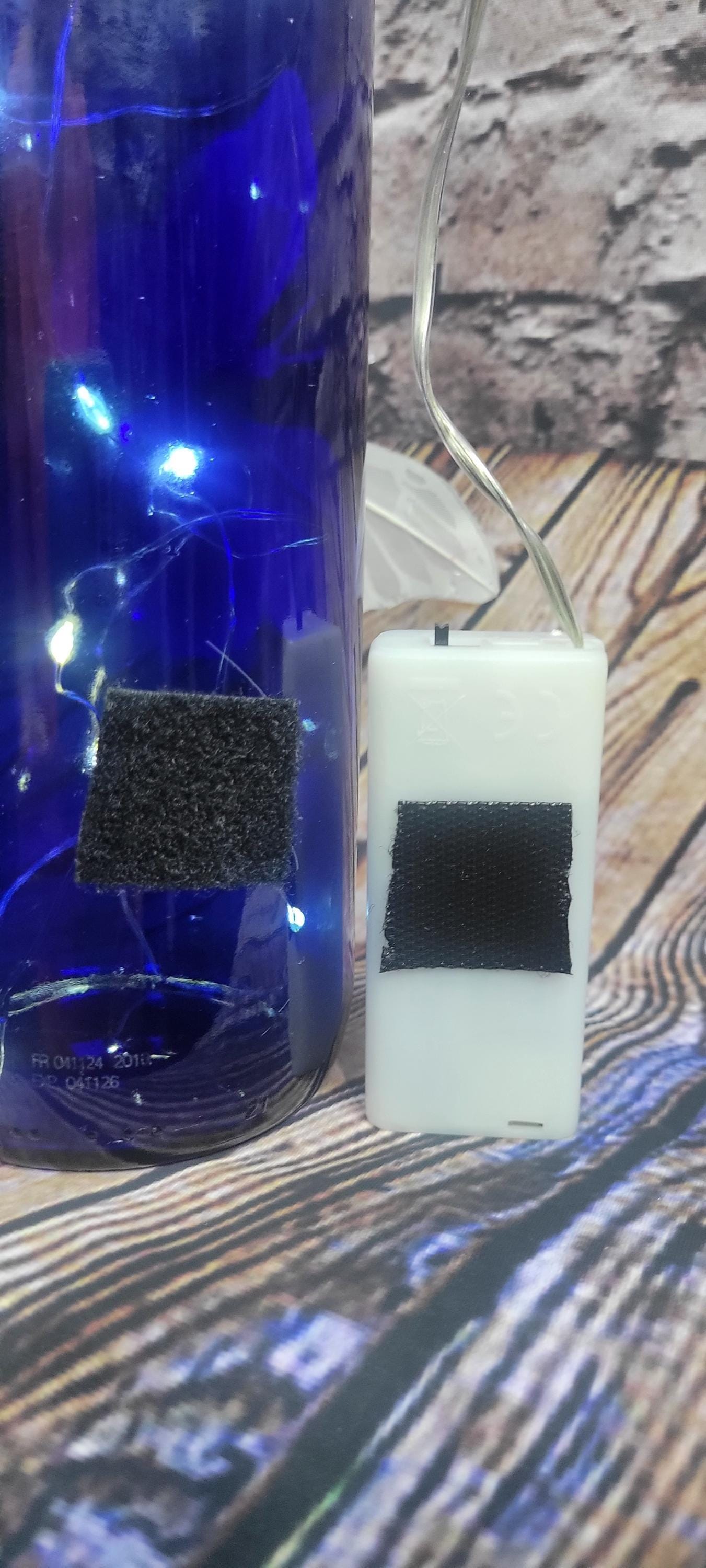 Cobalt blue wine bottle electric LED lights with white butterflies table decor centerpiece