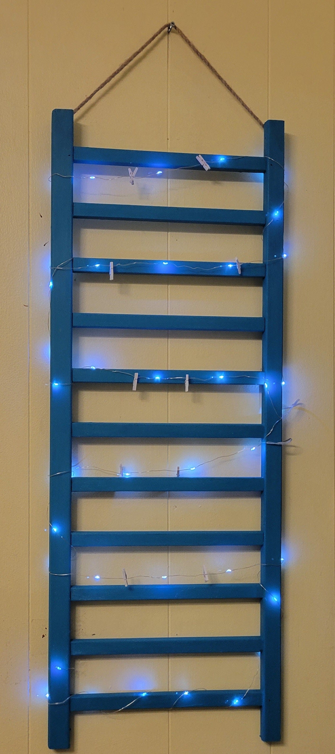 Repurposed Wood Ladder Photo Display: Vintage Crib Frame with Fairy Lights
