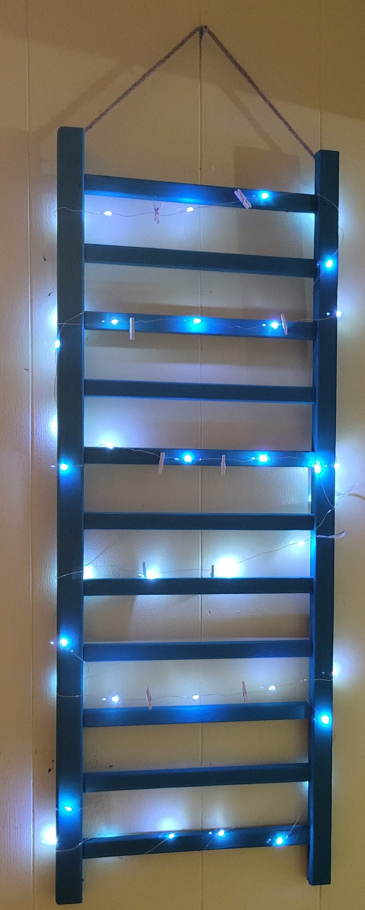 Repurposed Wood Ladder Photo Display: Vintage Crib Frame with Fairy Lights
