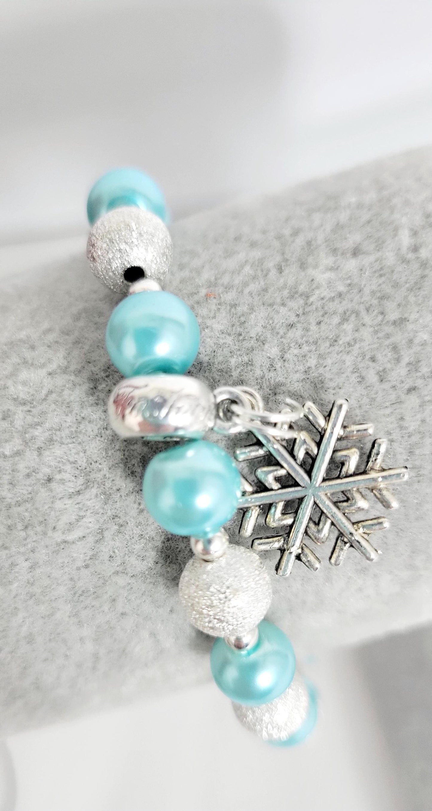 Ice blue glass beaded snowflake charm bracelet