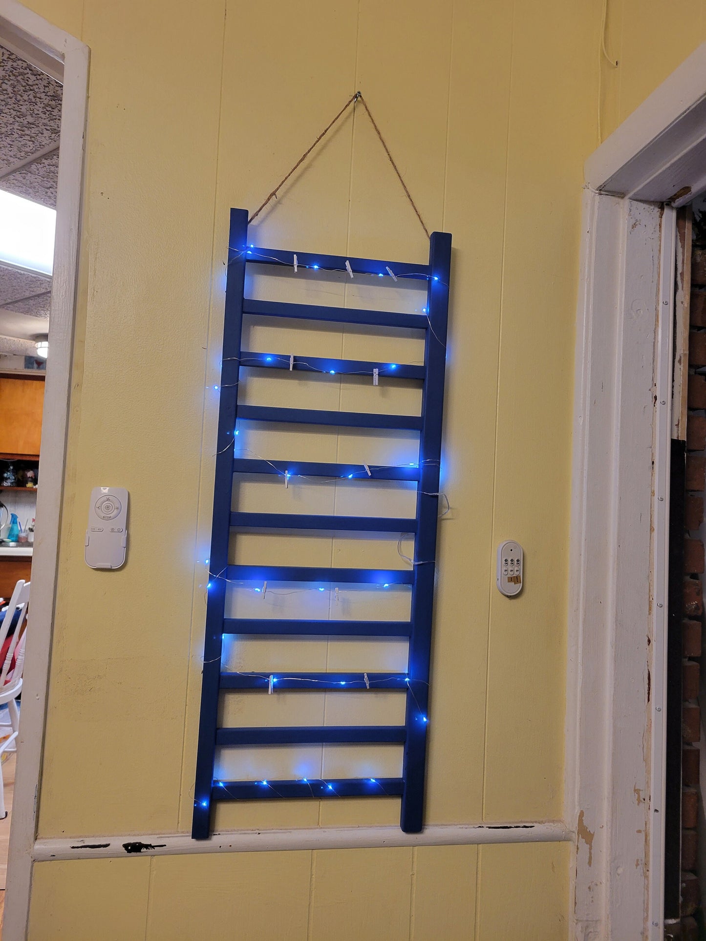 Repurposed Wood Ladder Photo Display: Vintage Crib Frame with Fairy Lights