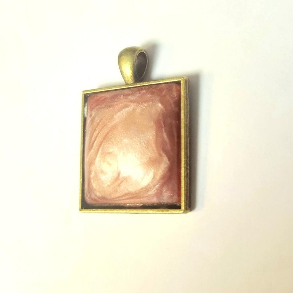 Rose resin bronze tone pendant