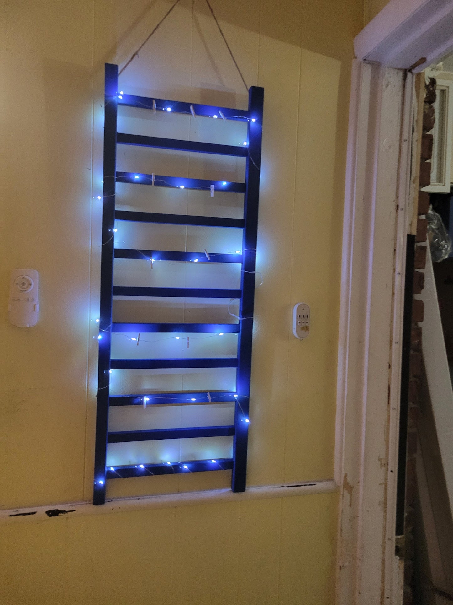 Repurposed Wood Ladder Photo Display: Vintage Crib Frame with Fairy Lights